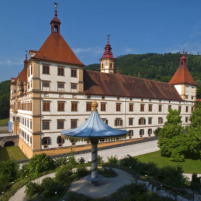 Seitenansicht des Schlosses Eggenberg mit dem Parapluie auf der Kuppe des Rosenhügels Seitenansicht des Schlosses Eggenberg mit dem Parapluie auf der Kuppe des Rosenhügels